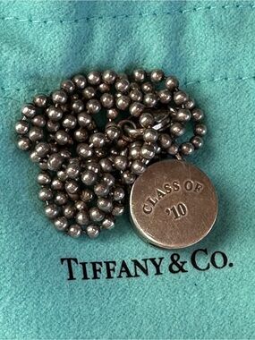 Tiffany & Co. Class of ‘10 Round Lock Charm Necklace.